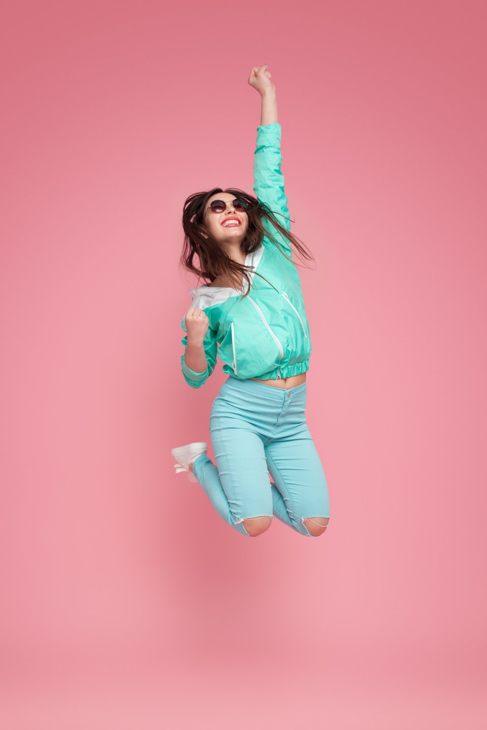 Cheerful woman jumping high